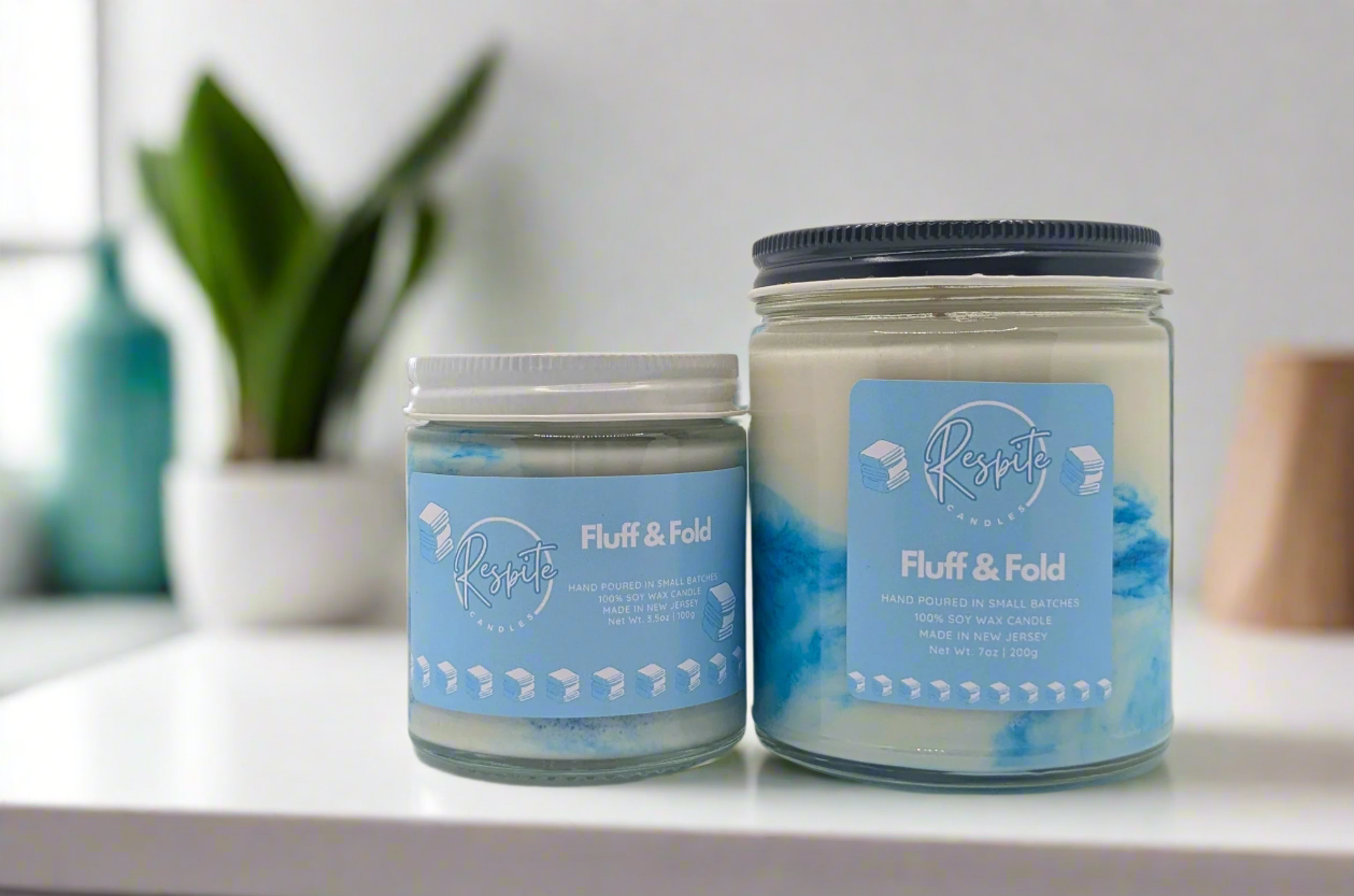 Two jars of 'Fluff & Fold' product with blue labels on a white background