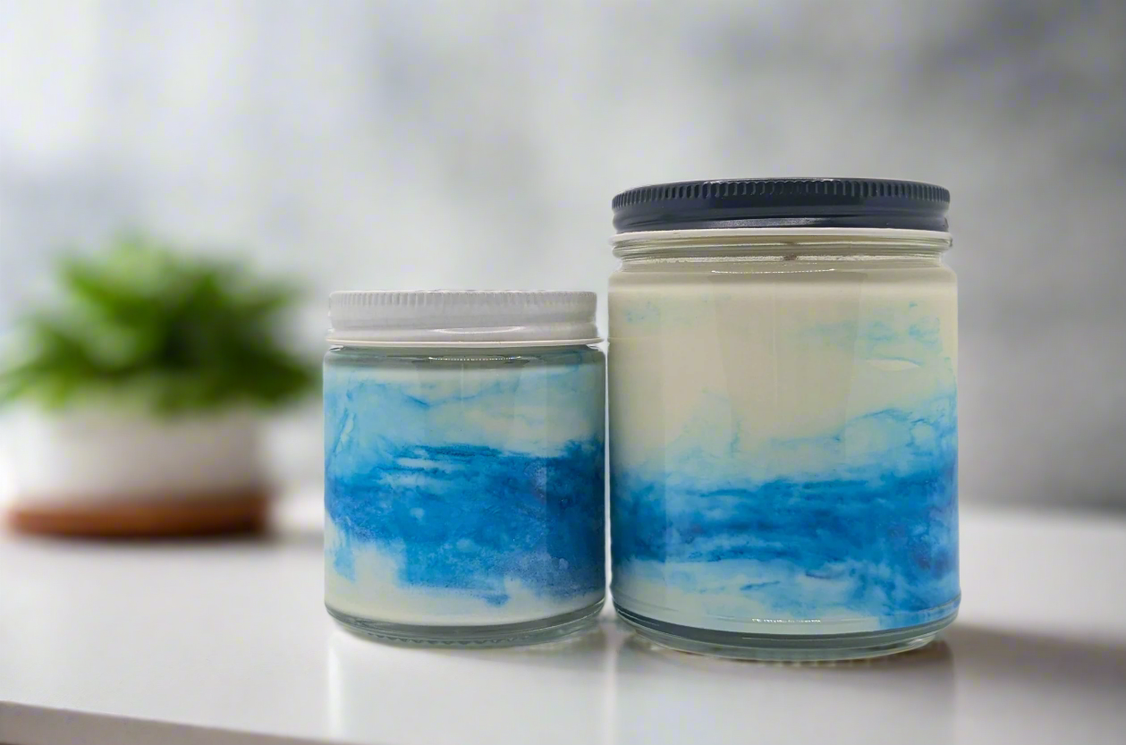 Two jars with blue and white marbled design on a white background