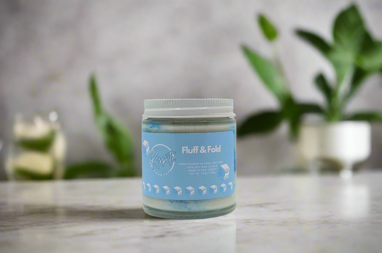 Jar of 'Fluff & Fold' product with a blue label on a white background