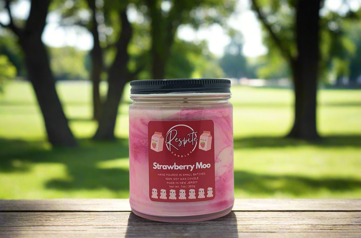 Pink candle jar with a label on a white background