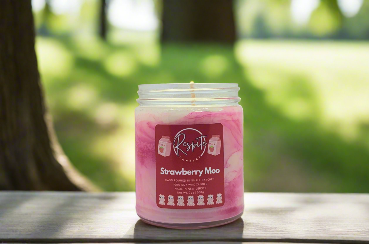 Pink and white candle with a label on a white background