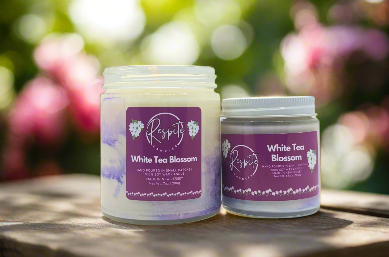 Two candles labeled 'White Tea Blossom' by 'respite' on a white background
