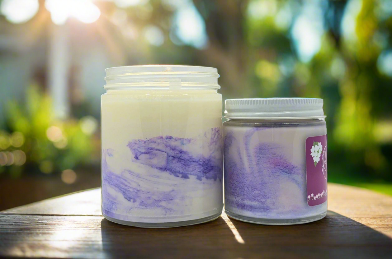 Two candles with purple and white marbled design on a white background