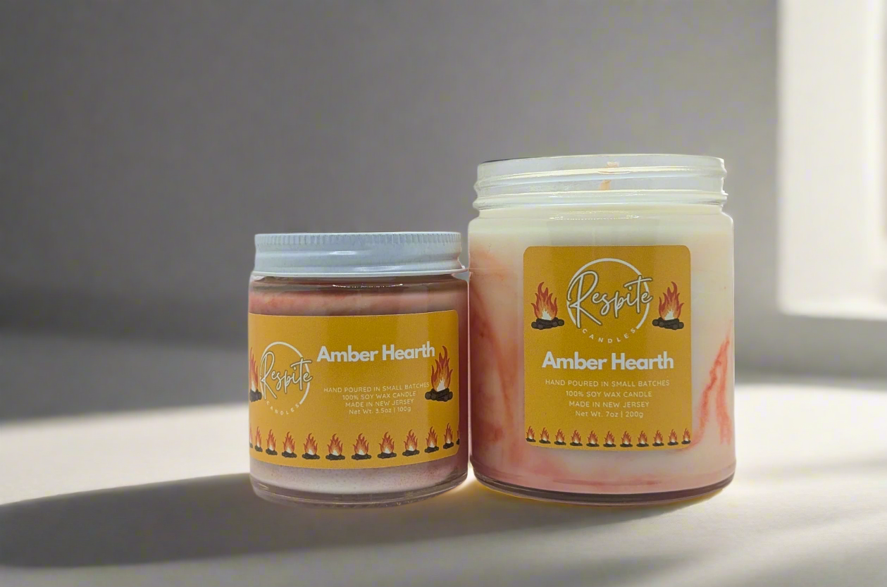 Two candles with 'Amber Hearth' label on a white background