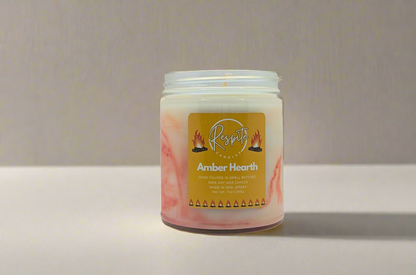 Candle jar labeled 'Amber Hearth' with a decorative label on a white background