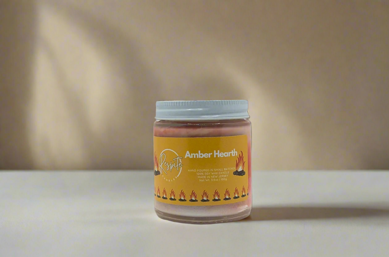Jar of Amber Hearth candle on a white background