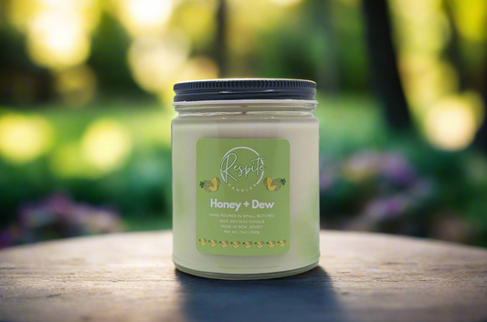 Candle jar labeled 'Honey + Dew' on a white background