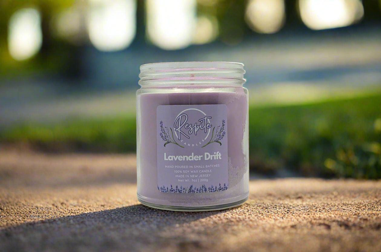 Purple candle jar labeled 'Lavender Drift' on a white background