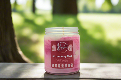 Pink and white candle with a label on a white background